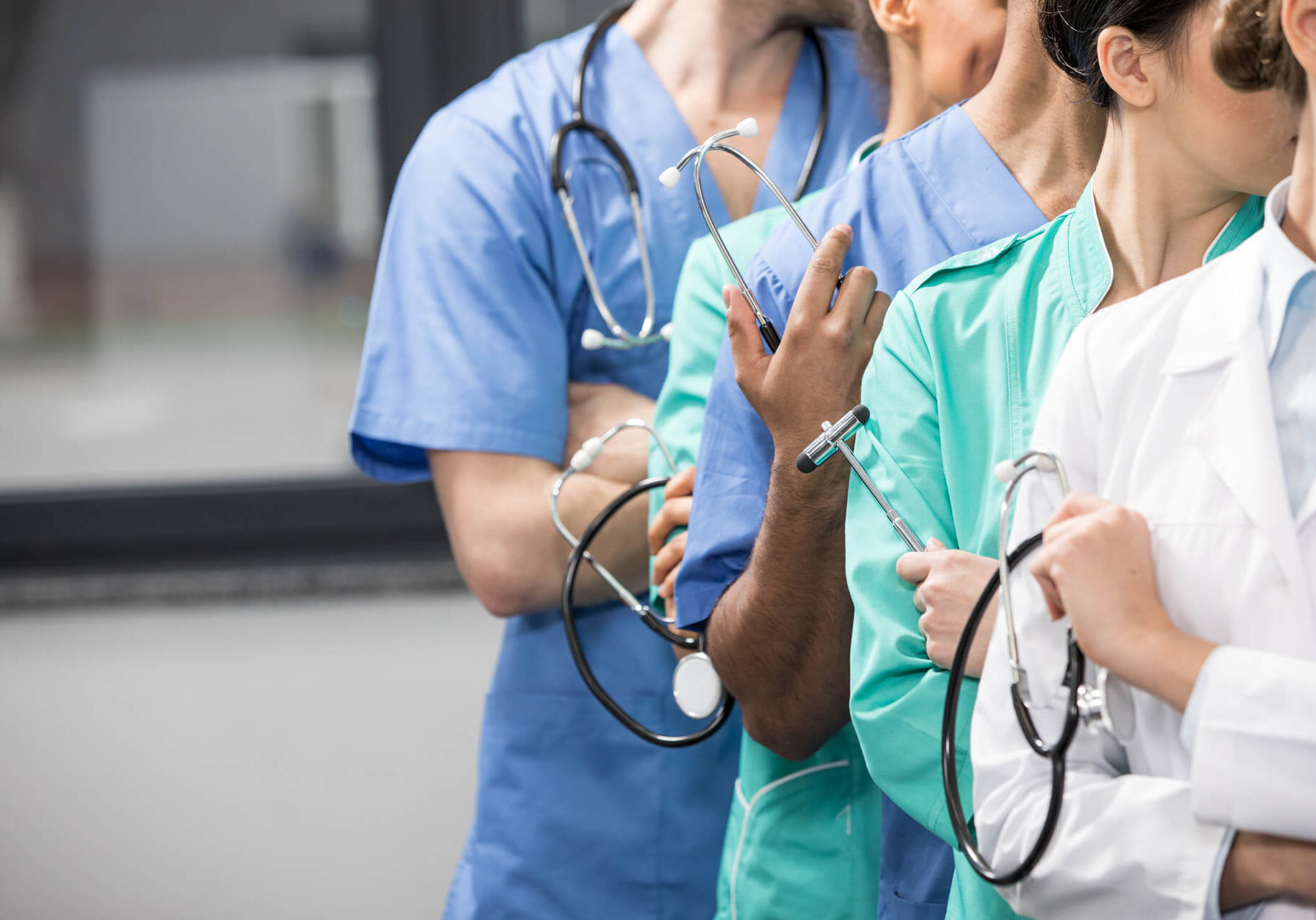 Partial view of group of medical workers with equipment